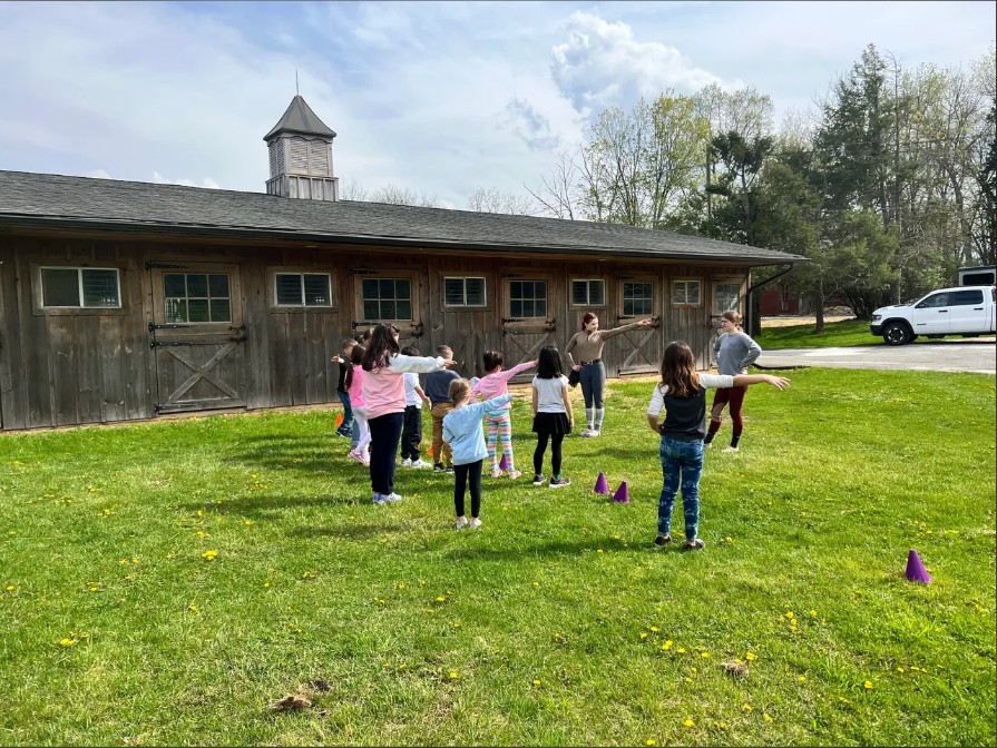 Campers doing a group activity on the Furlyn Farm lawn